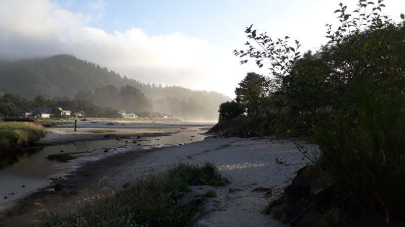Photo of a sunny afternoon at Neskowin, a cloud resting on the hills in the distance